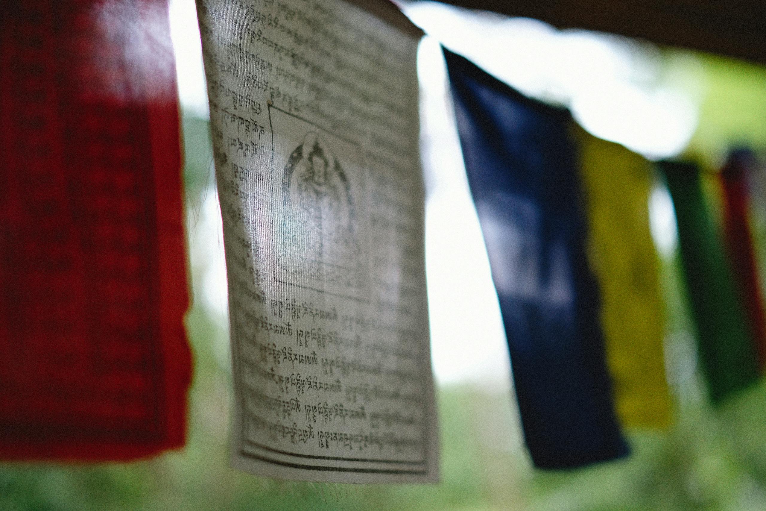 Vibrant Tibetan prayer flags with sacred texts hanging outdoors, evoking spirituality.